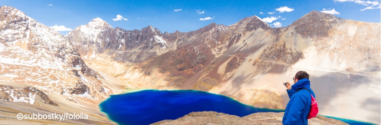 Photographing man tourist Bolivia mountains lake road.